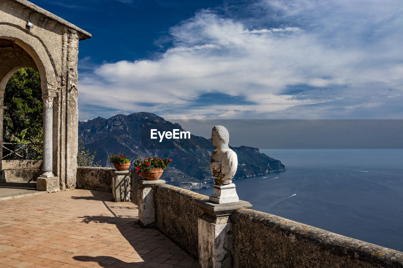 VIEW OF STATUE ON SEA AGAINST CLOUDY SKY