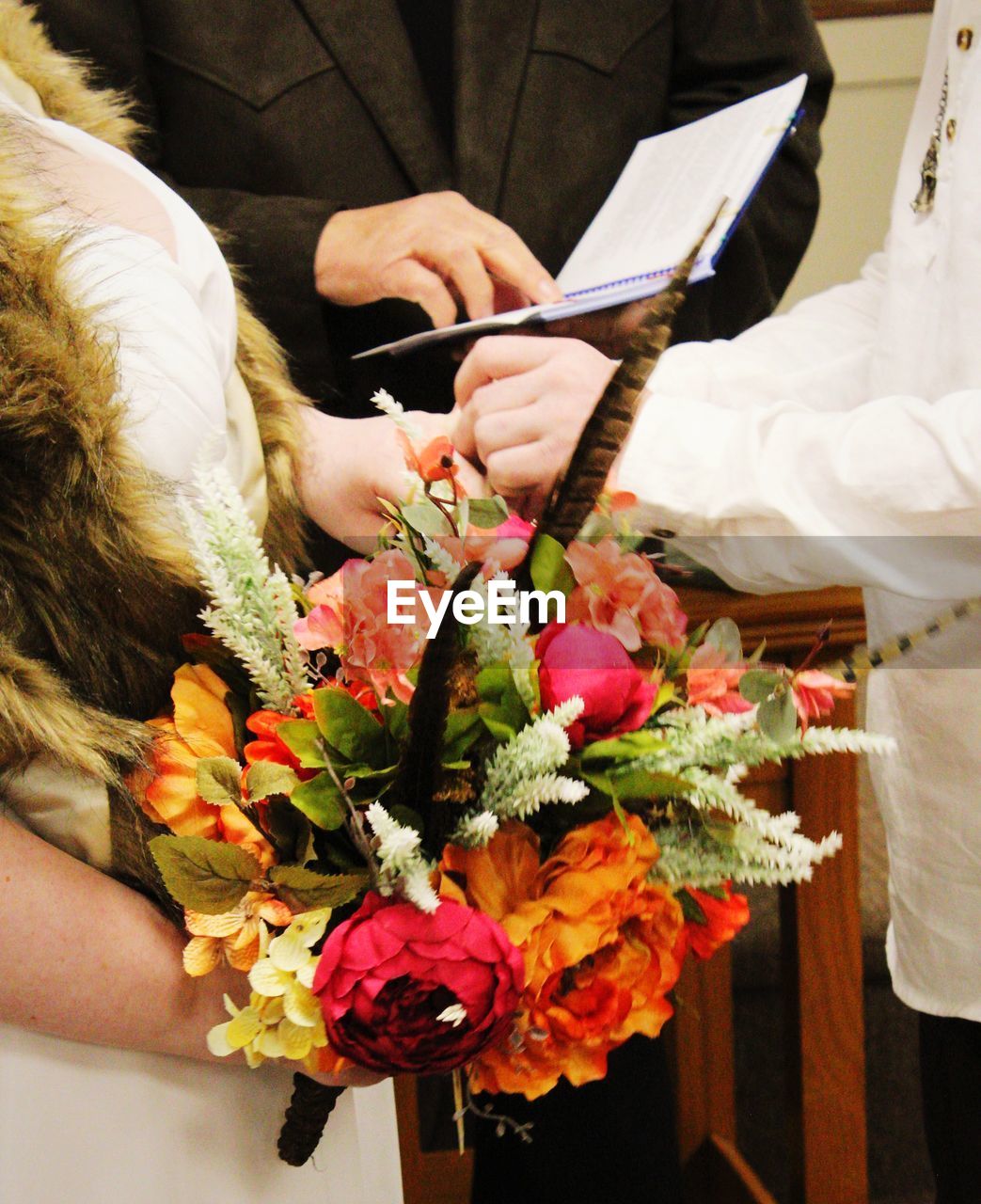 Couple saying their vows, bride's bouquet 