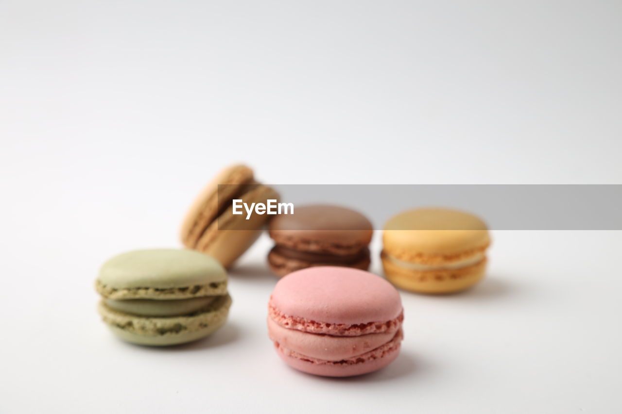 CLOSE-UP OF MACAROONS AGAINST WHITE BACKGROUND