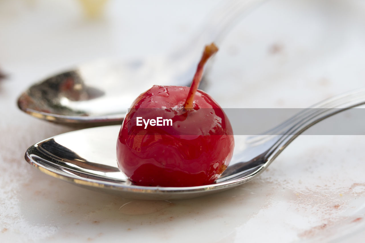 Close-up of cherry on spoon