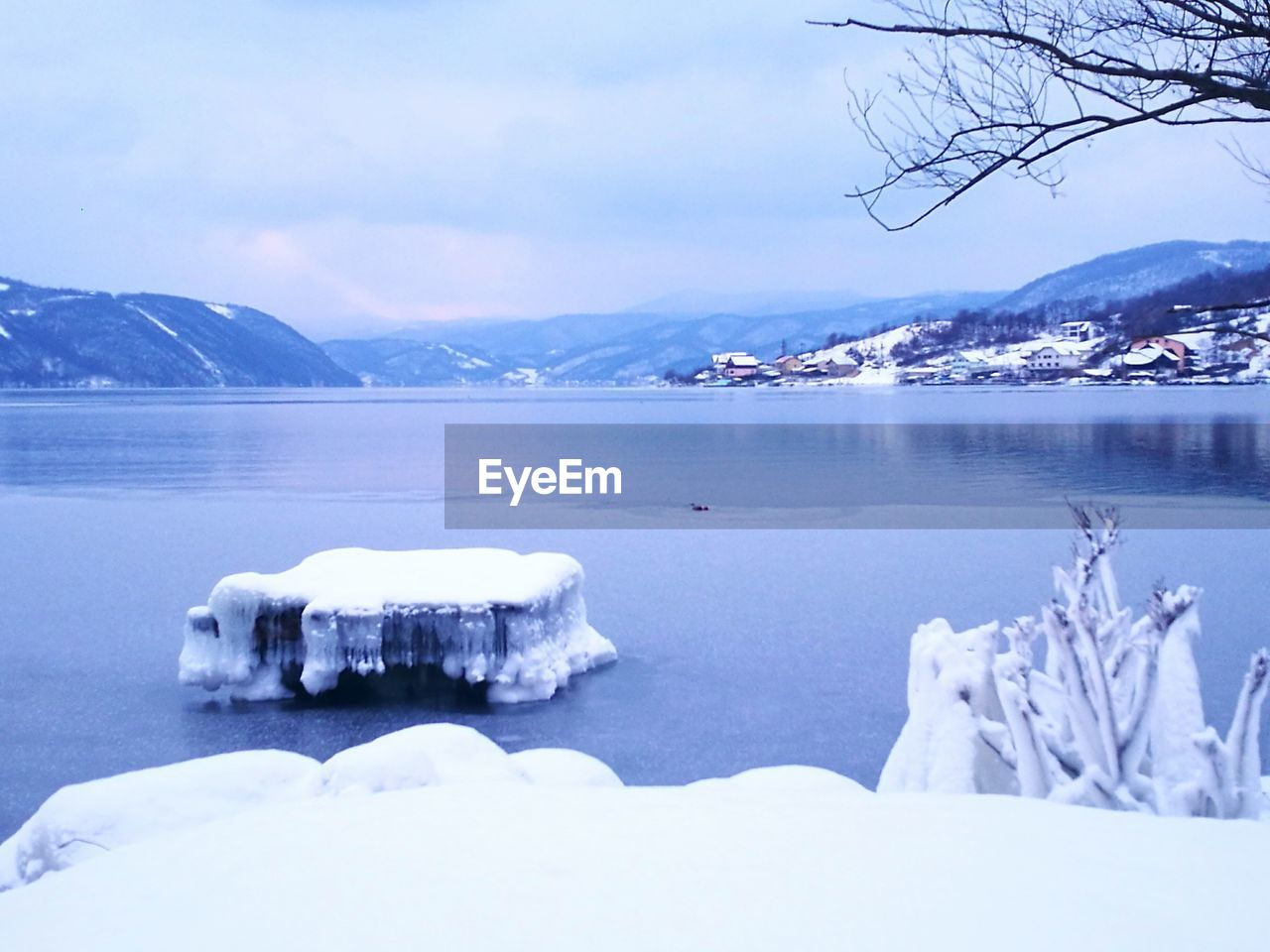 SCENIC VIEW OF FROZEN LAKE AGAINST MOUNTAIN