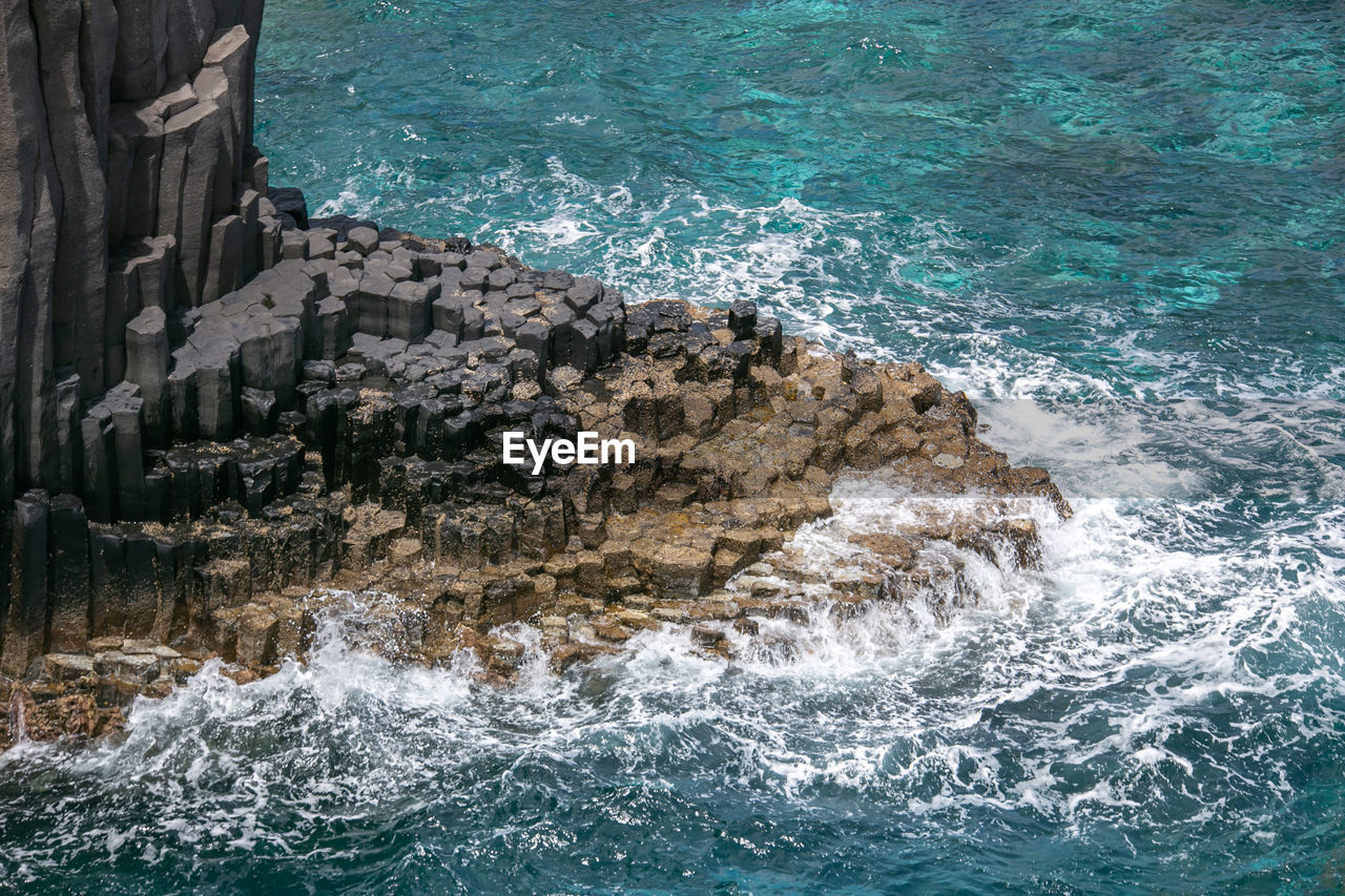 Sea waves splashing on rocks