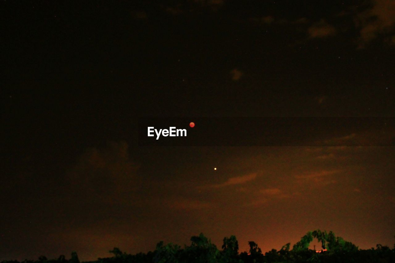 LOW ANGLE VIEW OF SILHOUETTE MOON AT NIGHT