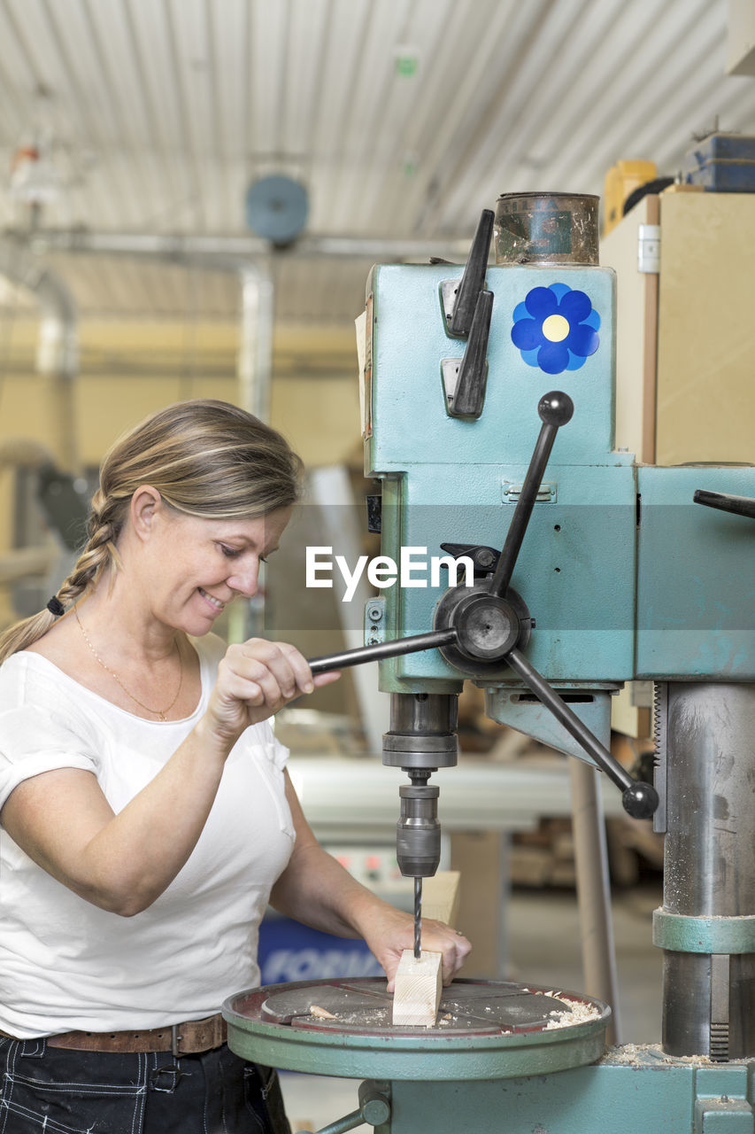 Smiling woman working in workshop