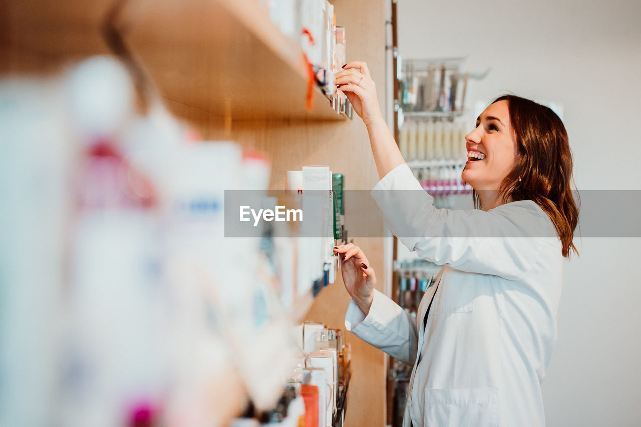 Smiling female pharmacist working at store