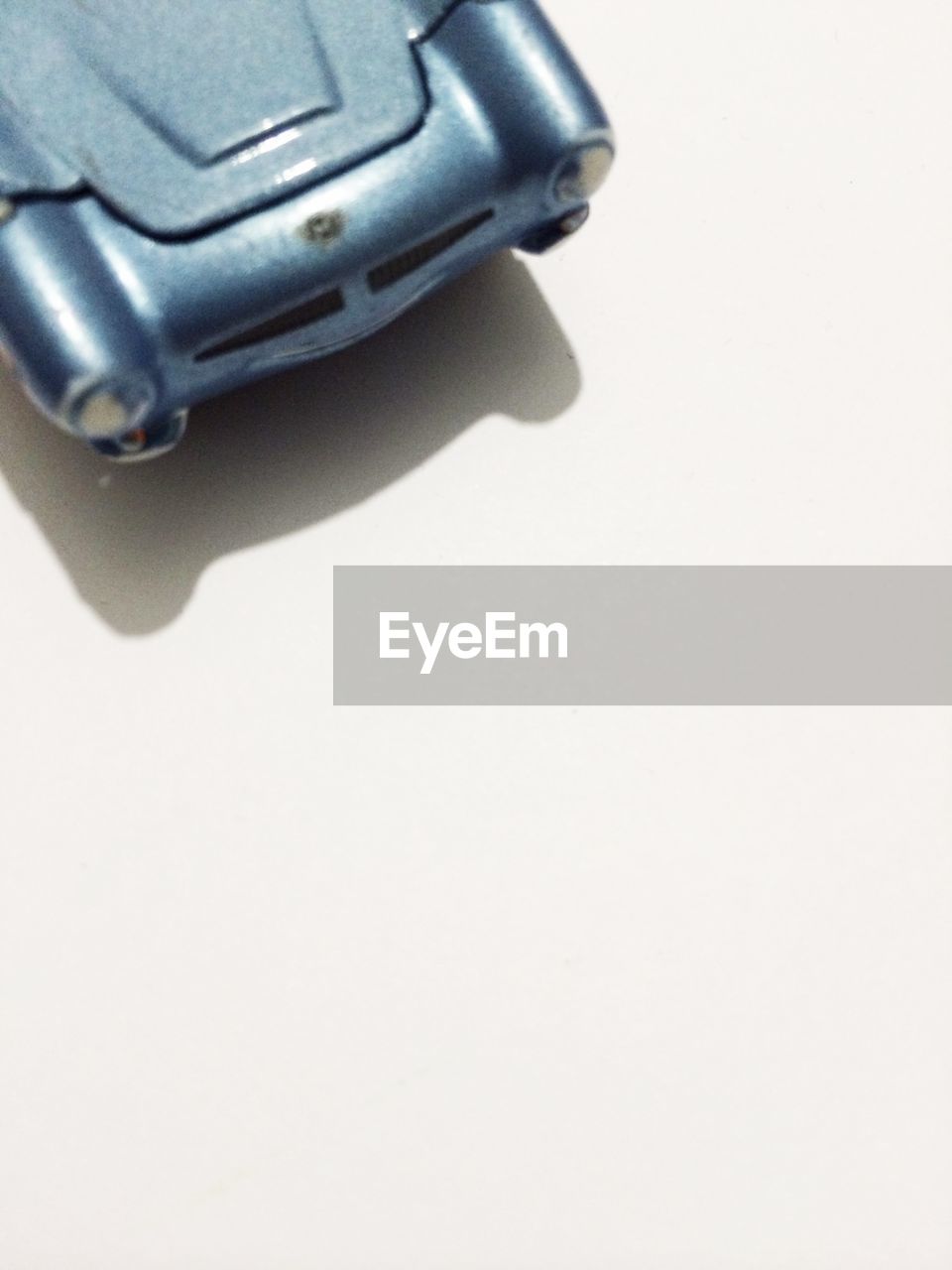 Cropped image of miniature car against white background