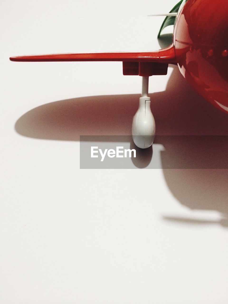 Cropped image of toy airplane over white background