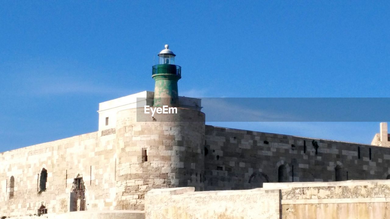 LOW ANGLE VIEW OF FORT AGAINST CLEAR BLUE SKY