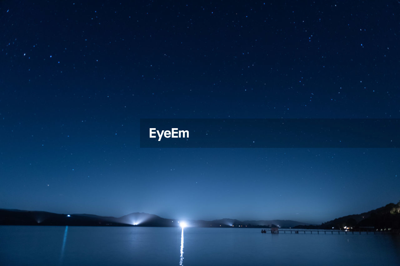 Scenic view of sea against sky at night