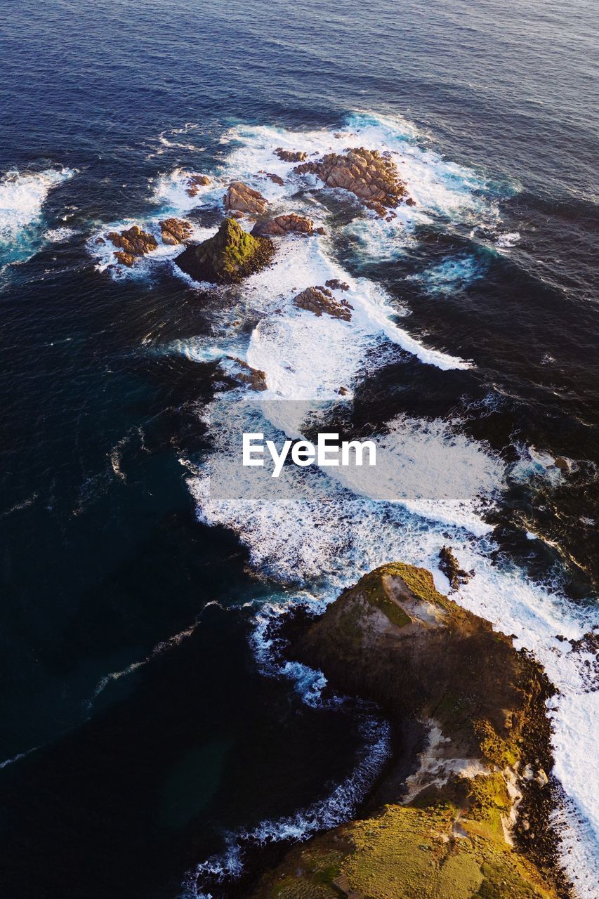 HIGH ANGLE VIEW OF ROCKS ON BEACH