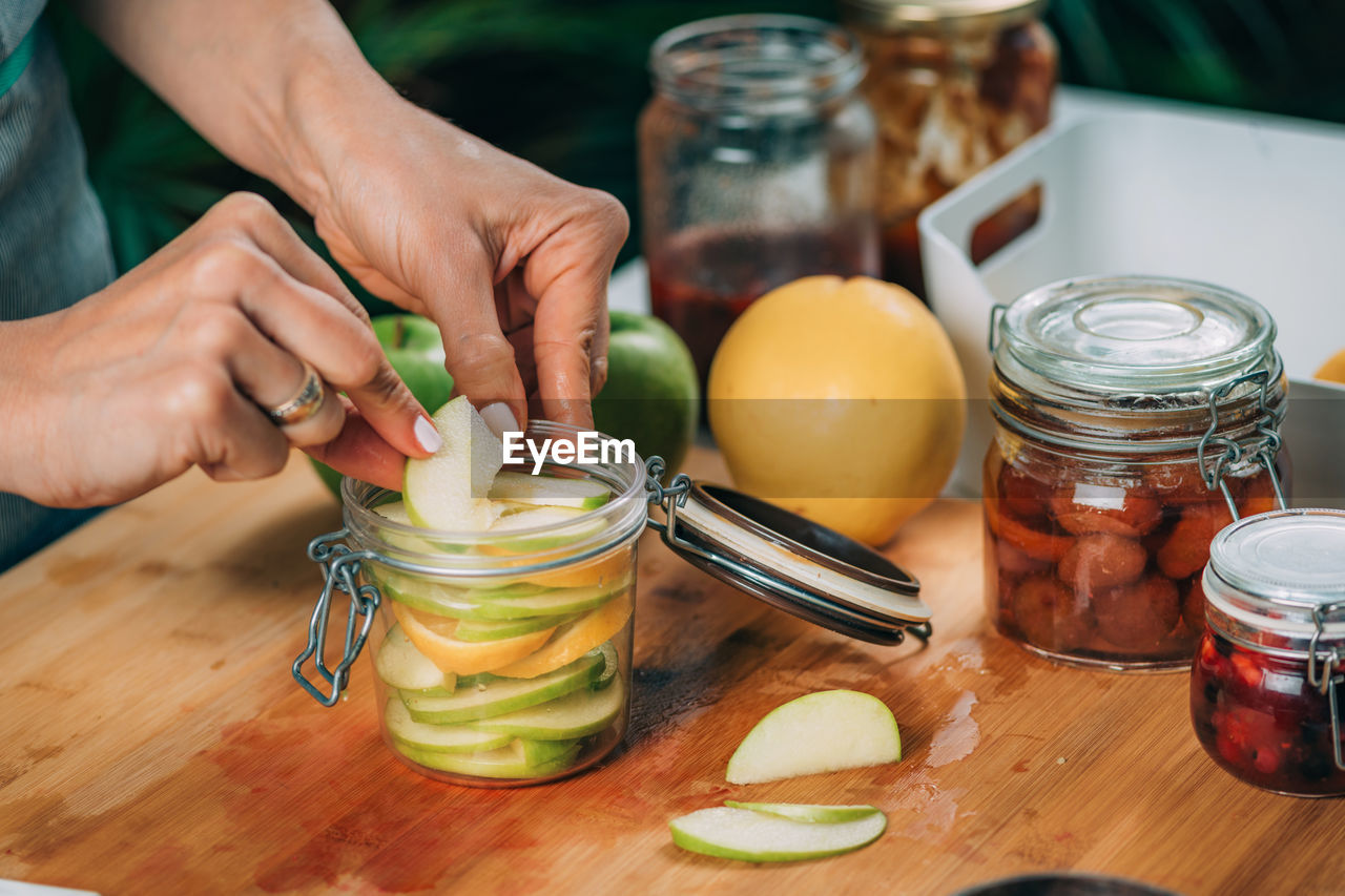 Fermentation food at home. woman preparing fruits for fermentation.