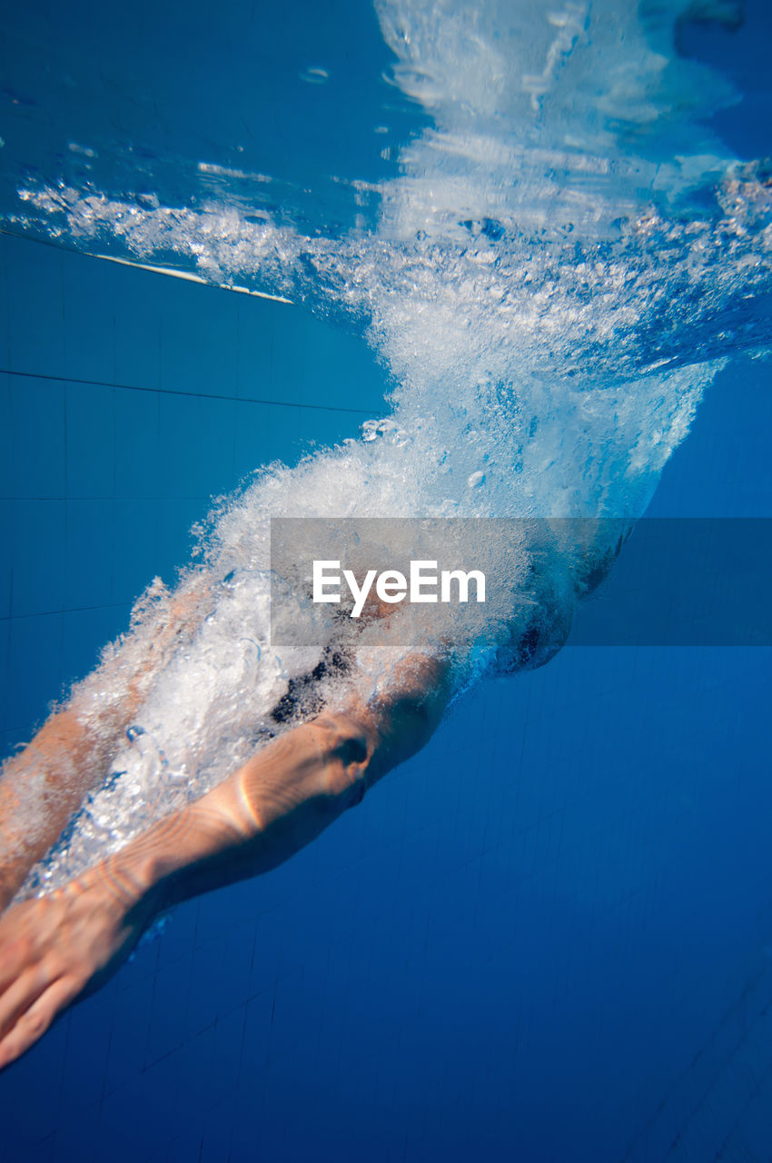 Mid adult woman swimming in pool