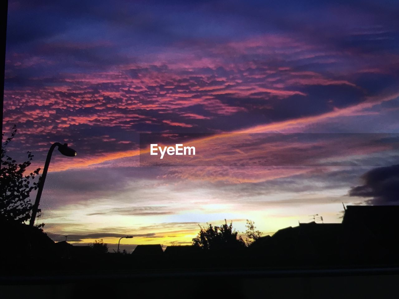 LOW ANGLE VIEW OF DRAMATIC SKY OVER SILHOUETTE LANDSCAPE