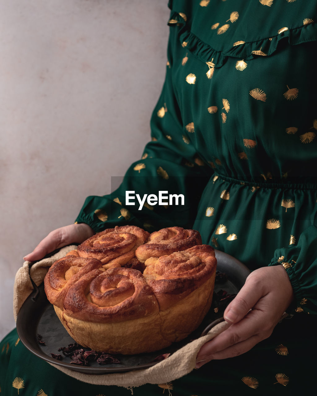 Midsection of woman holding a cake 