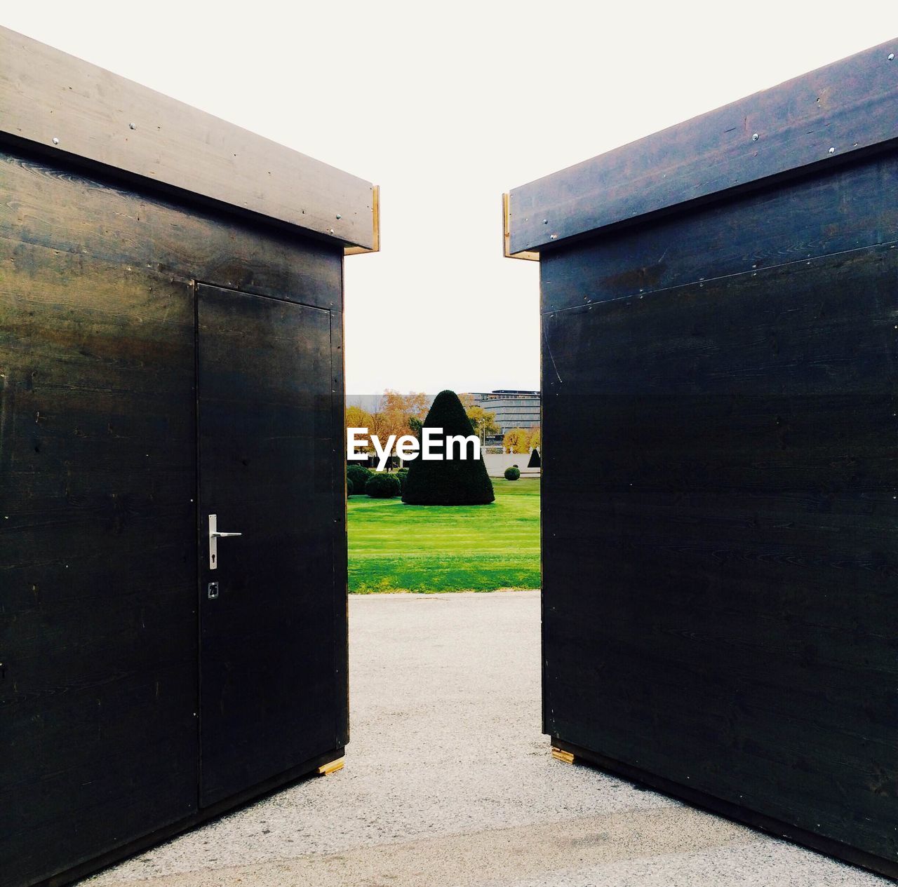 Ajar wooden gate of park