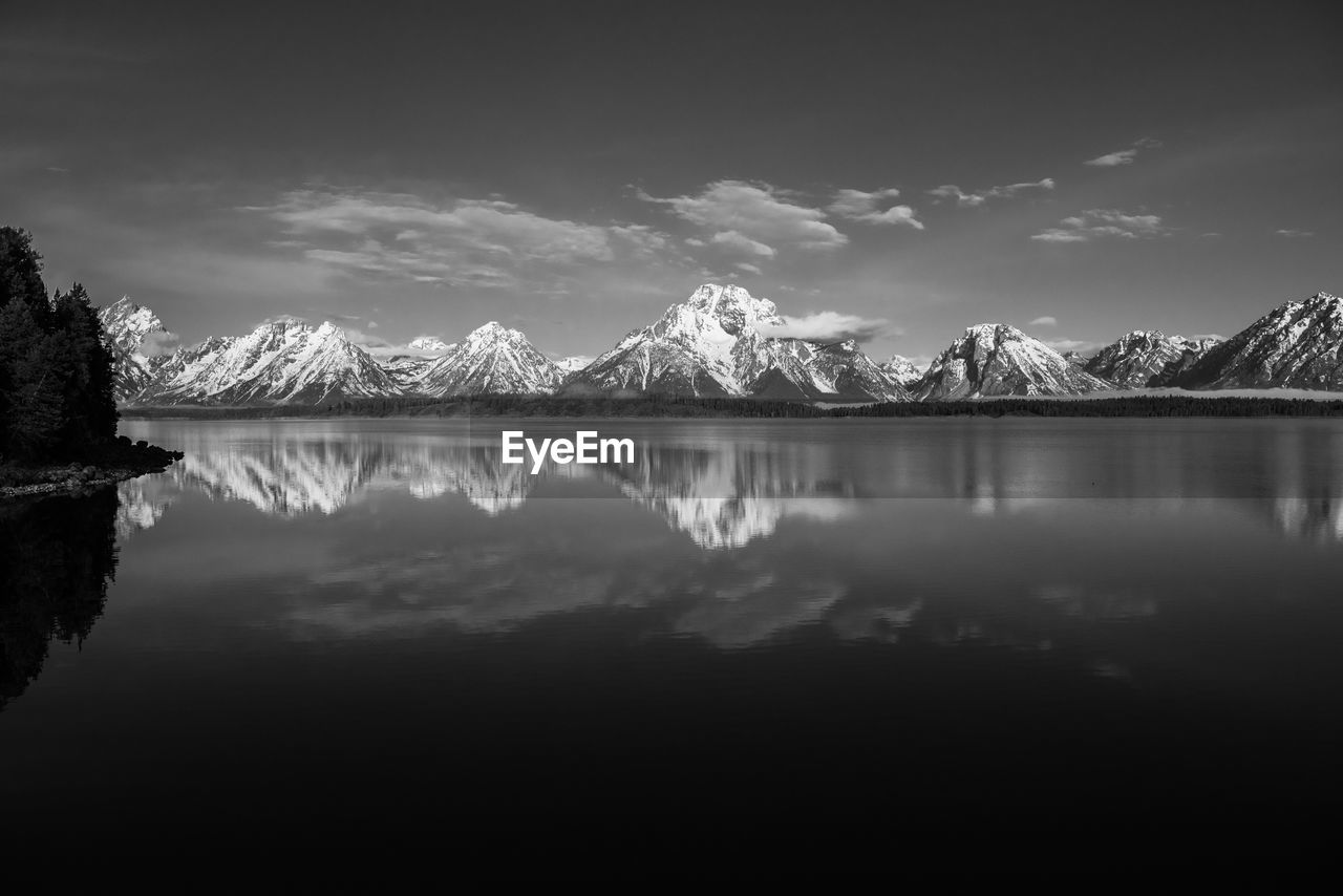 Scenic view of lake against sky at night