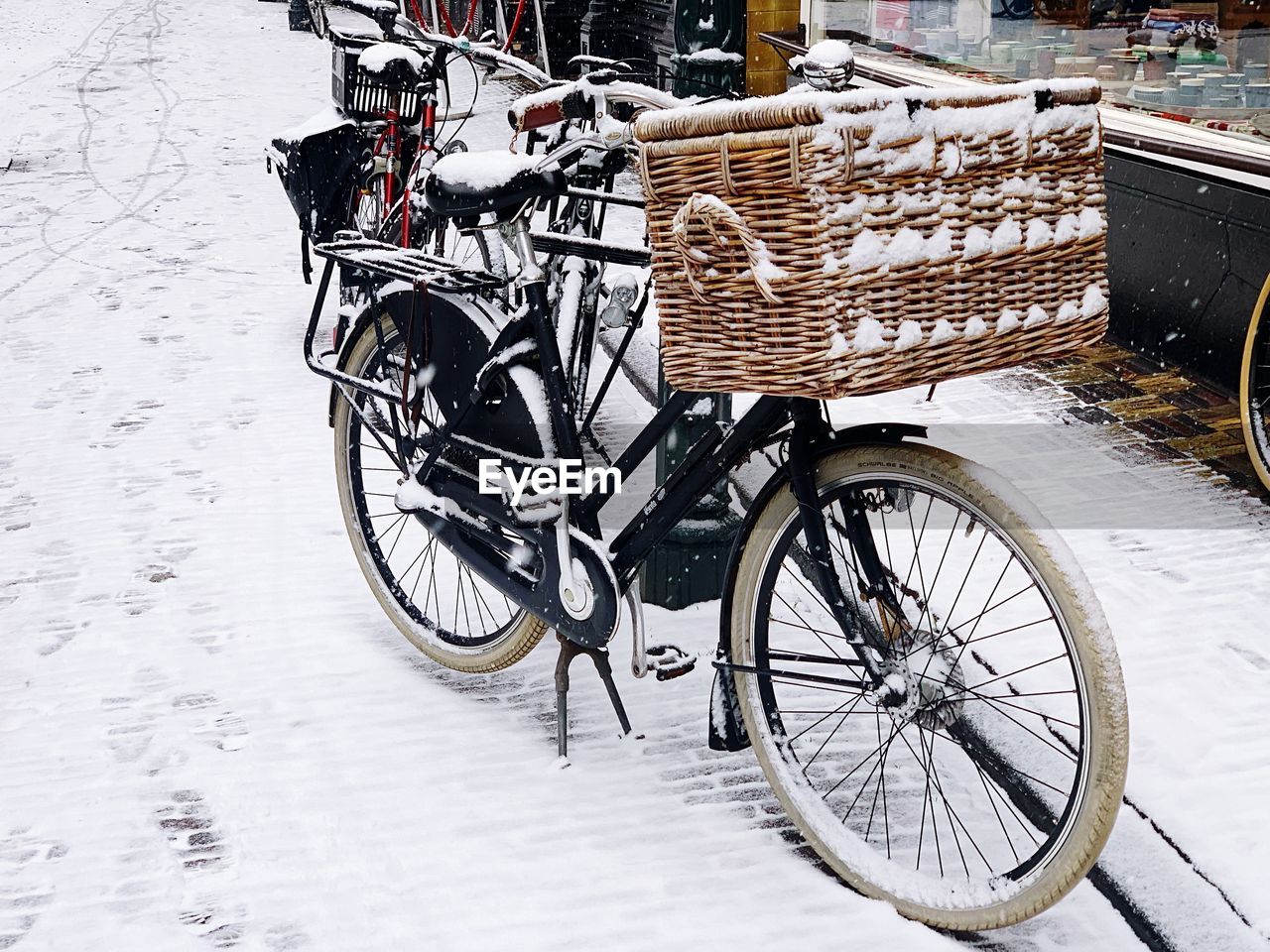 Bicycle parked on snowy road