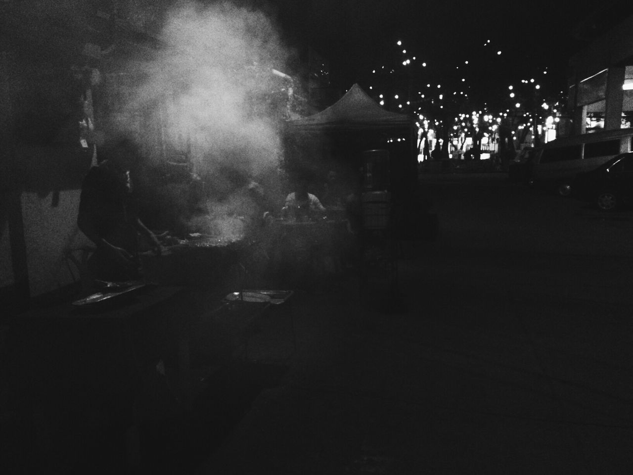 Man cooking at open restaurant at night