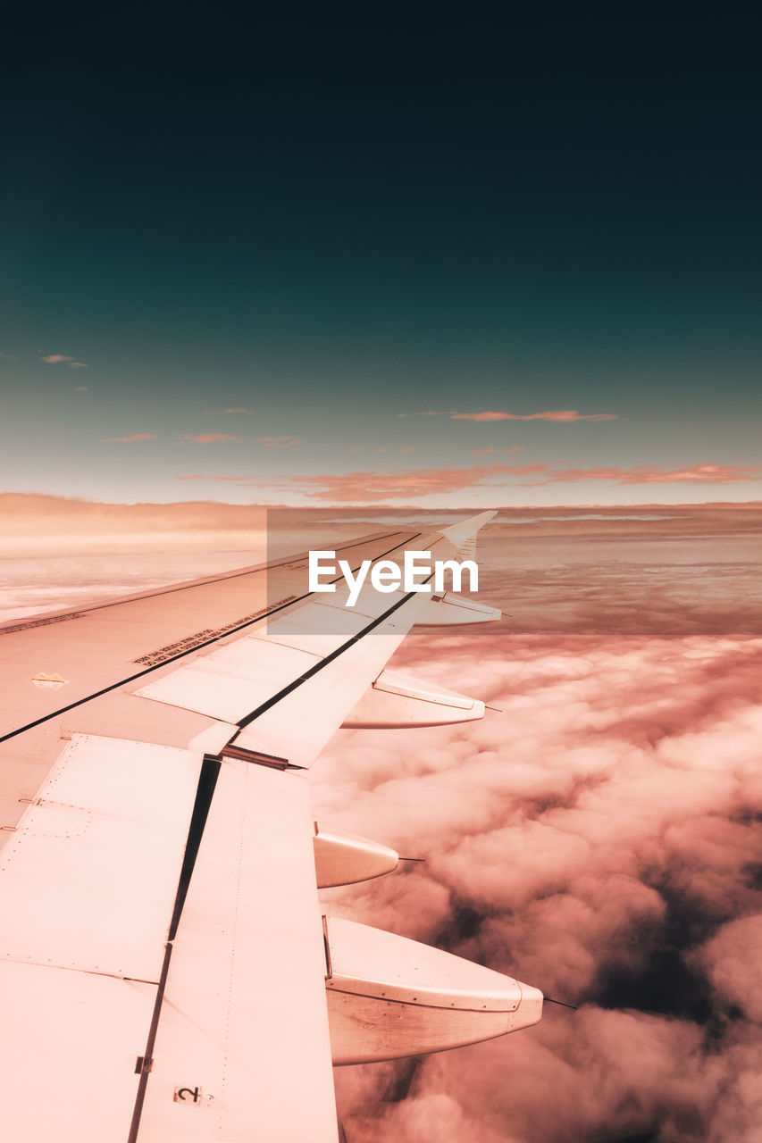 VIEW OF AIRPLANE WING AGAINST SKY