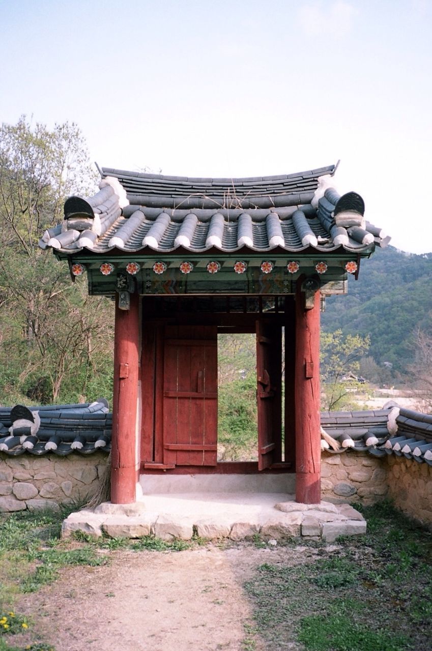 Built structure on landscape against the sky