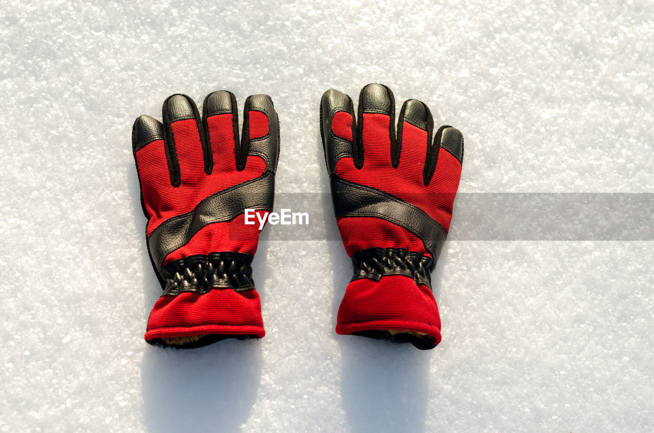 High angle view of gloves on snow covered land