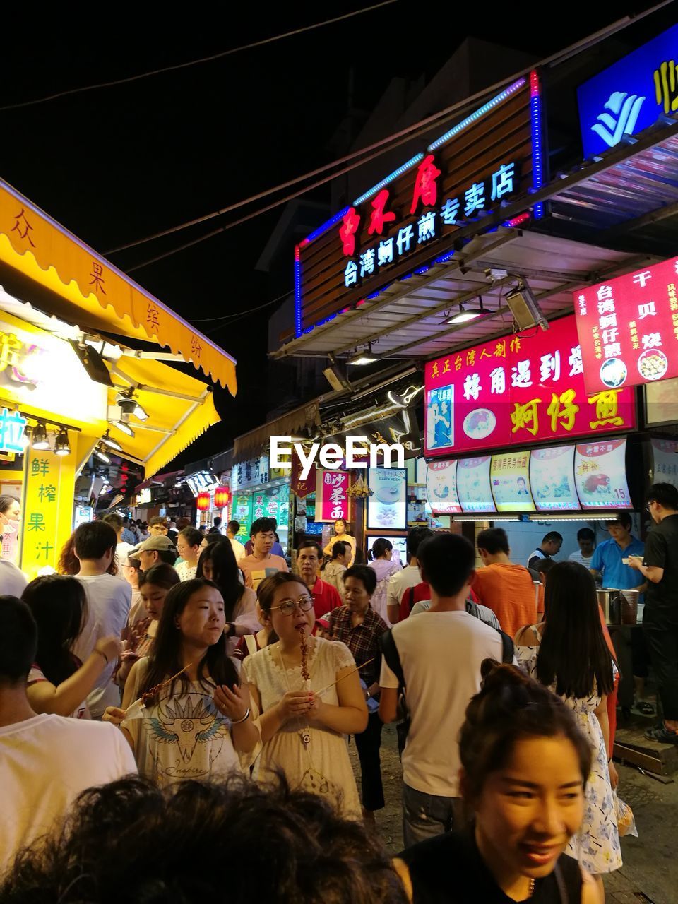 CROWD AT MARKET IN CITY AT NIGHT