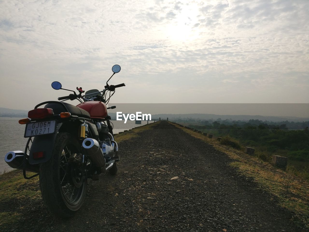 BICYCLE ON DIRT ROAD AMIDST FIELD