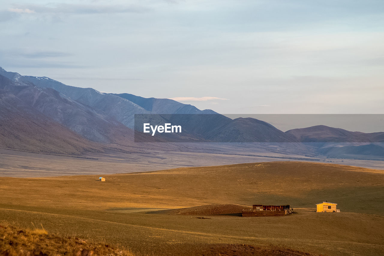 SCENIC VIEW OF FIELD AND MOUNTAINS AGAINST SKY