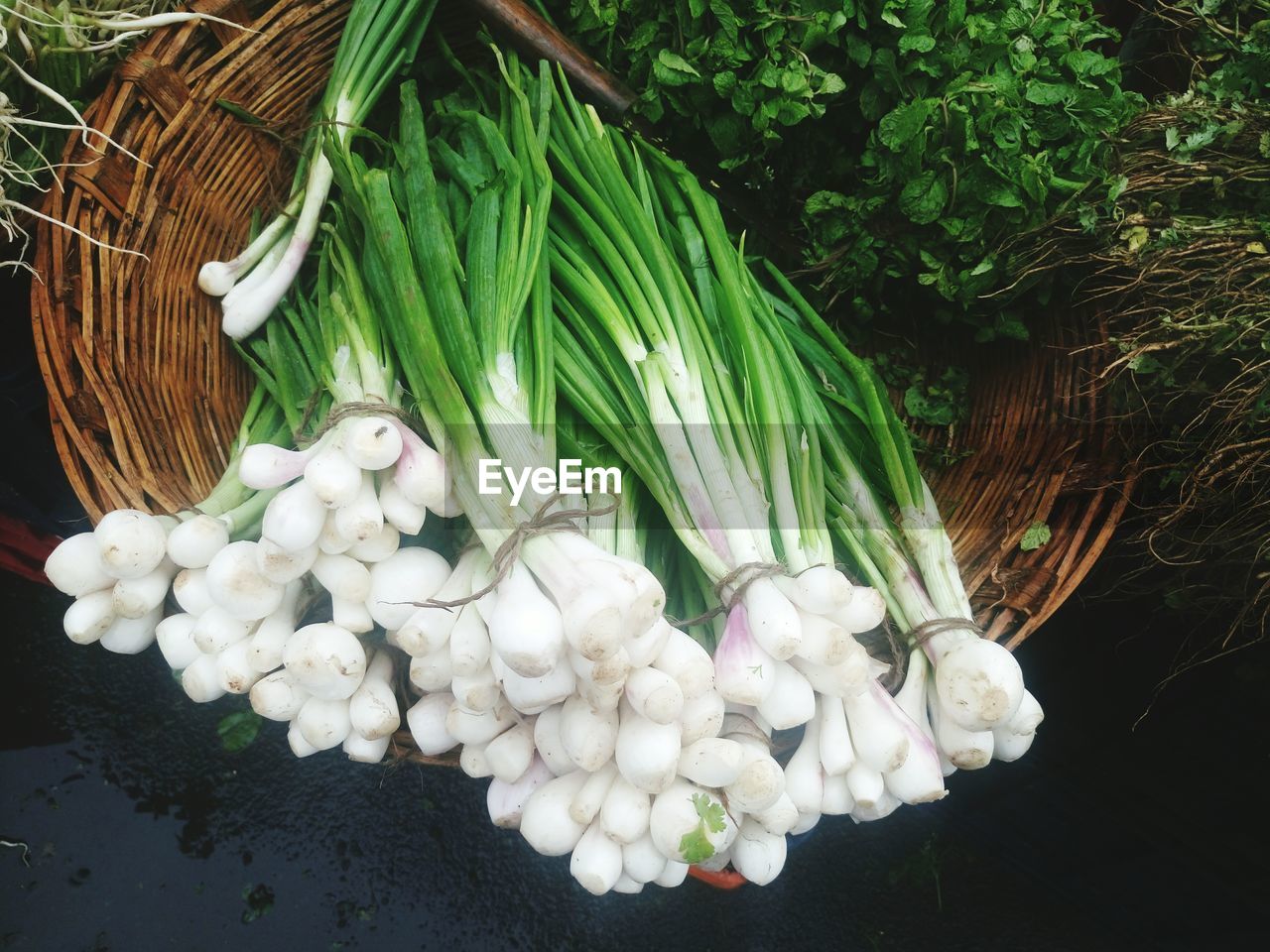 High angle view of scallions in basket at market