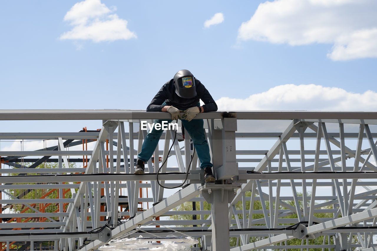 rear view of woman standing on bridge