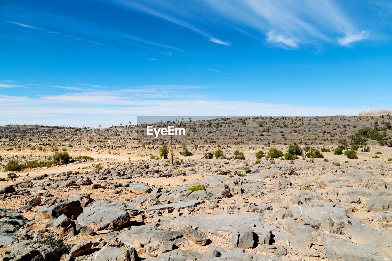 Idyllic shot of desert landscape against blue sky