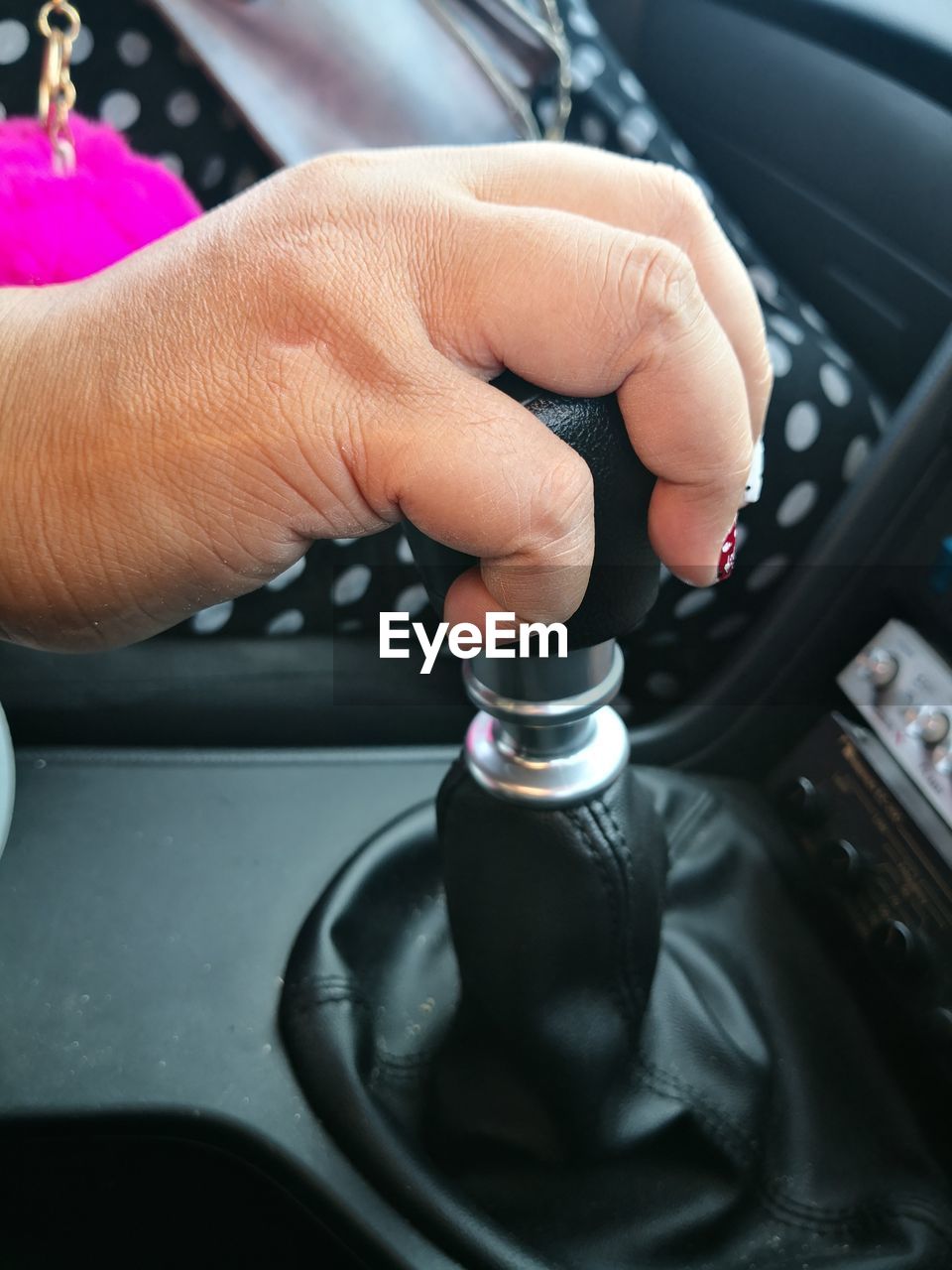 Close-up of woman holding gearshift in car