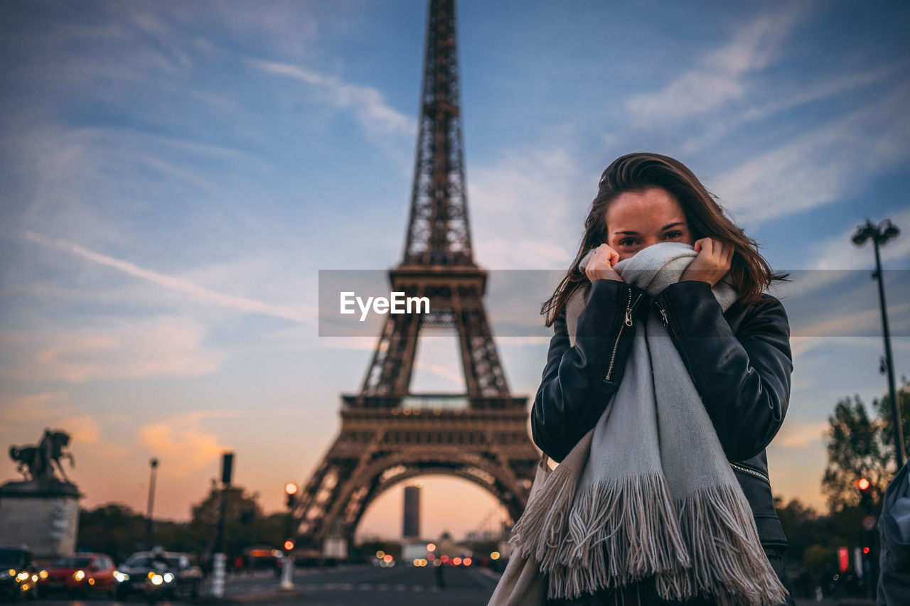 Portrait of woman standing with eiffel tower in background