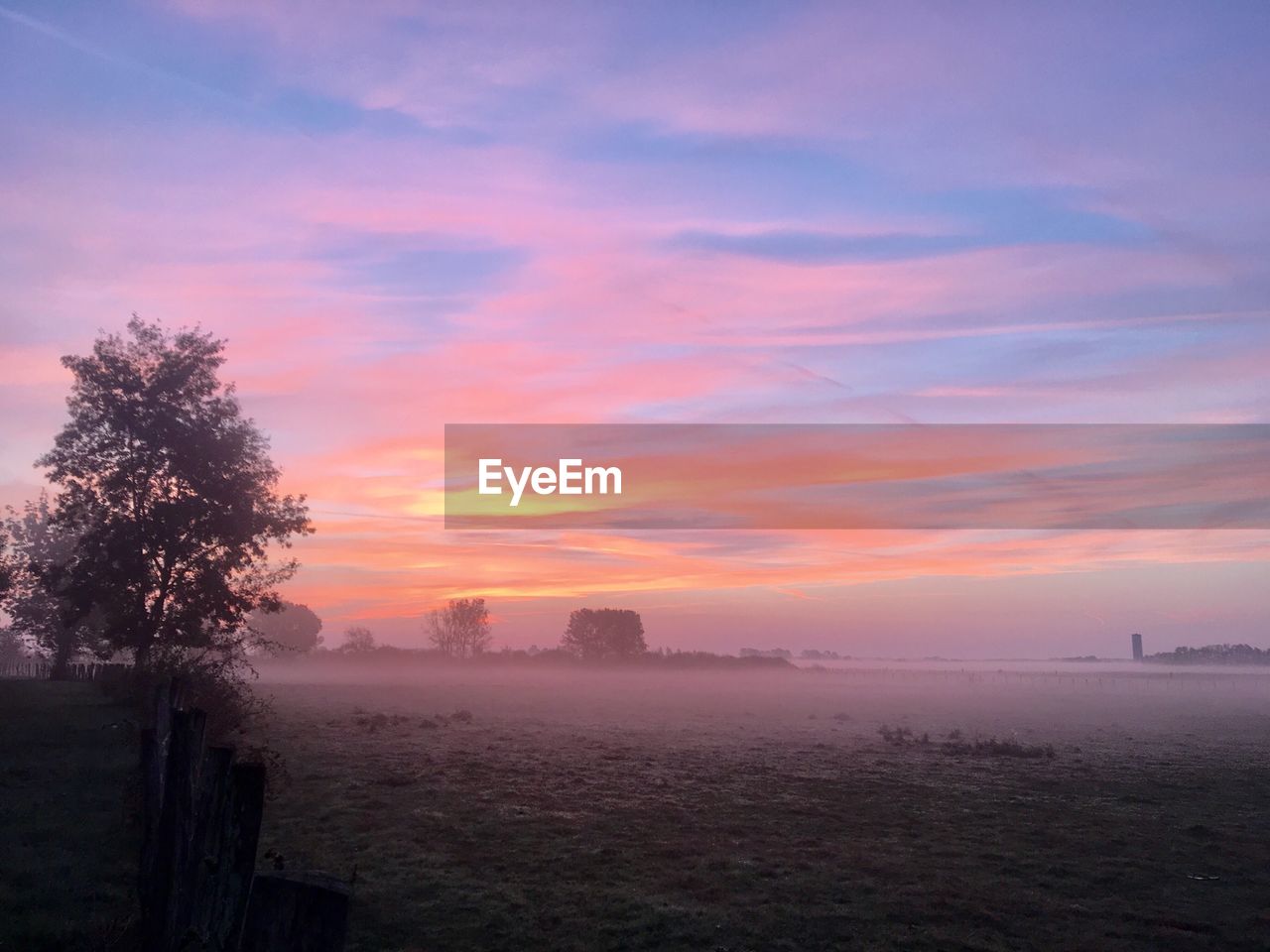 Scenic view of field against sky during sunset