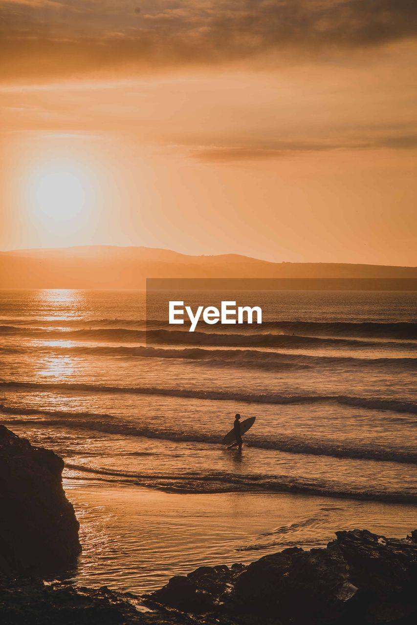 Scenic view of beach against sky during sunset