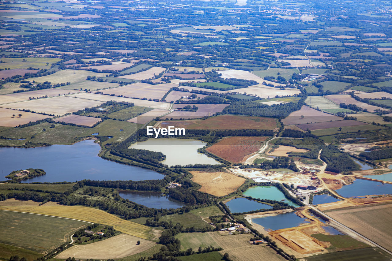 AERIAL VIEW OF RIVER AMIDST FIELD