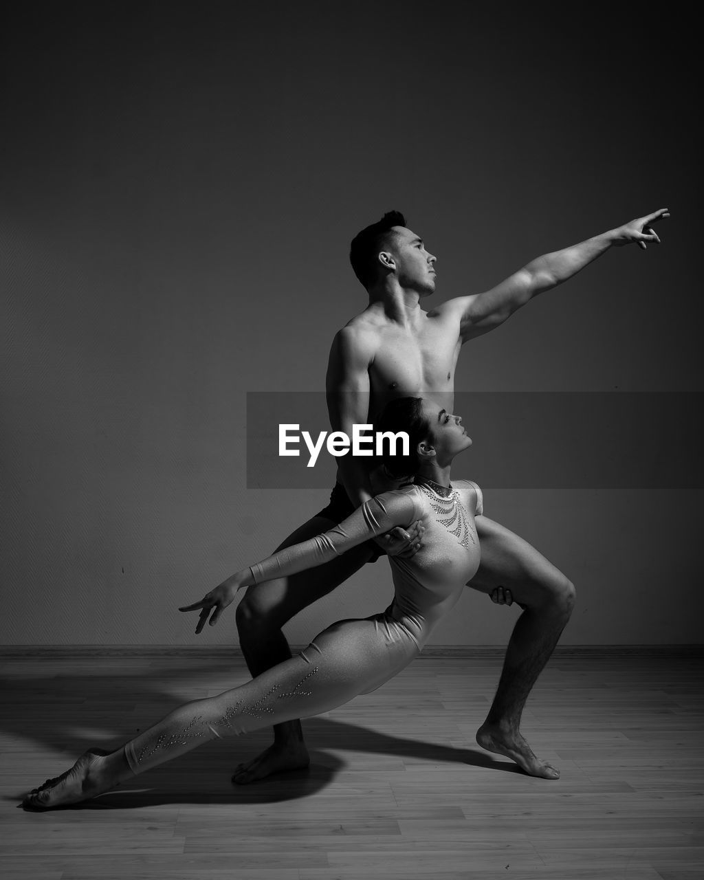 Full length of shirtless man dancing against white background