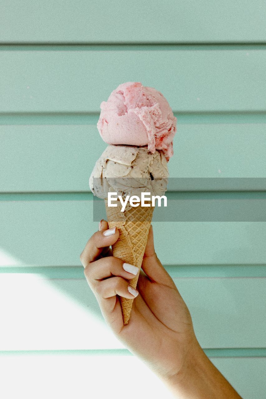 Cropped hand of woman holding ice cream cone 