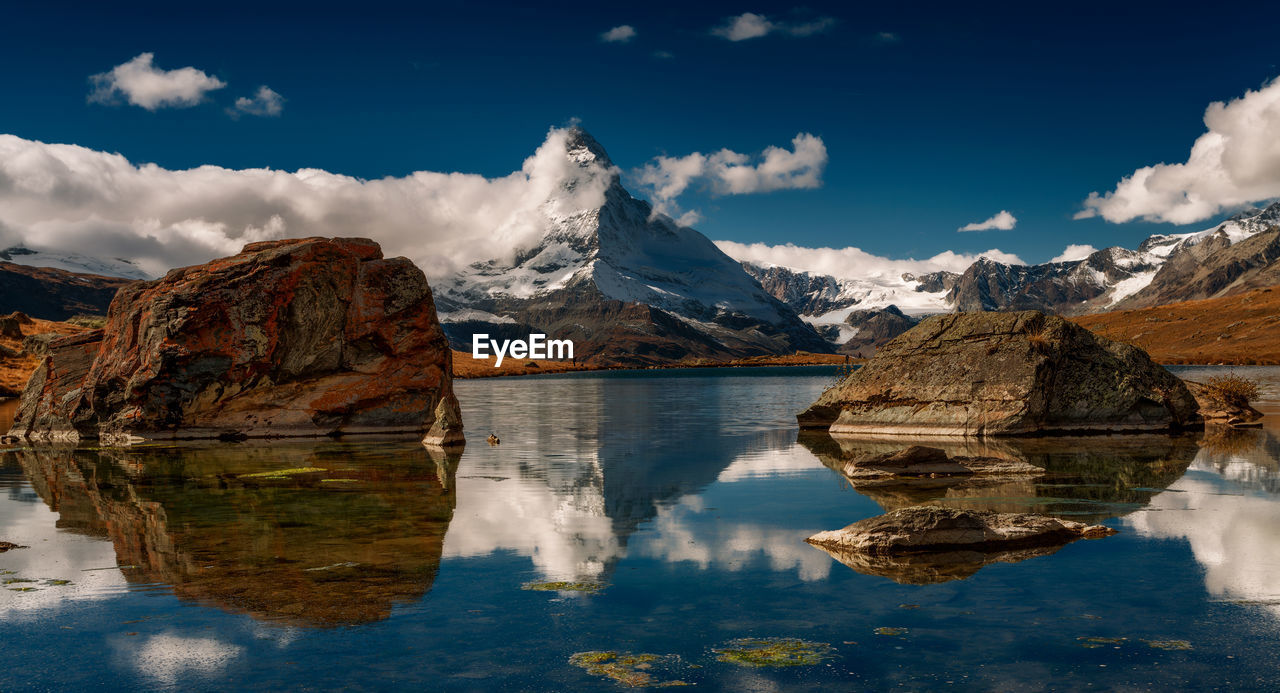 Panoramic view of lake and snowcapped mountains against sky