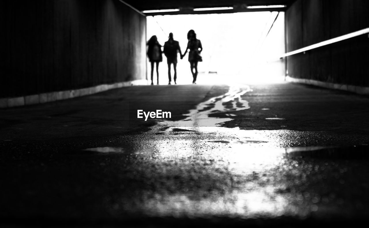 Friends walking in tunnel