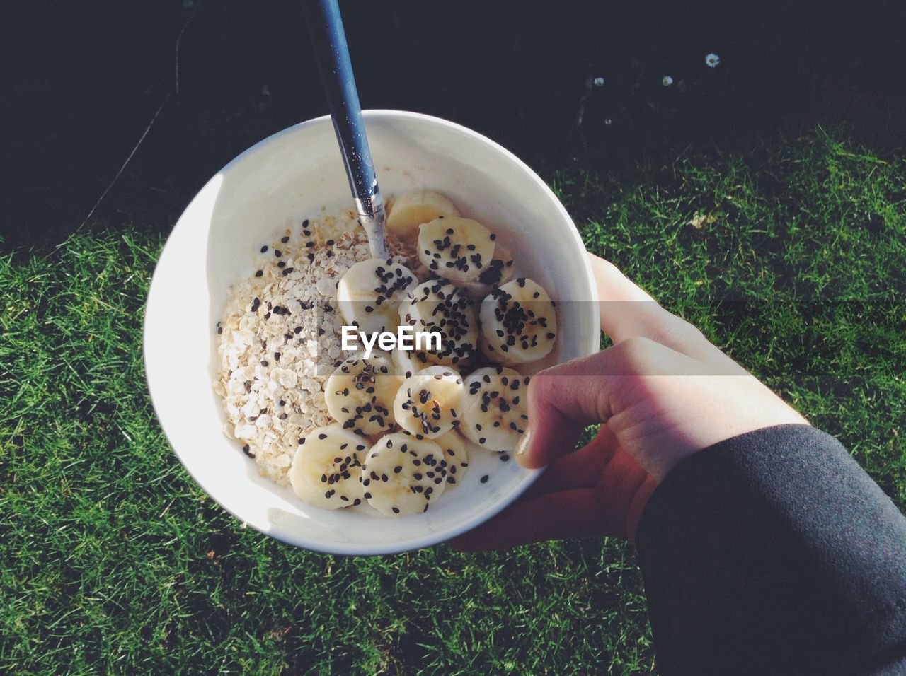 Cropped image of woman holding bowl of healthy breakfast