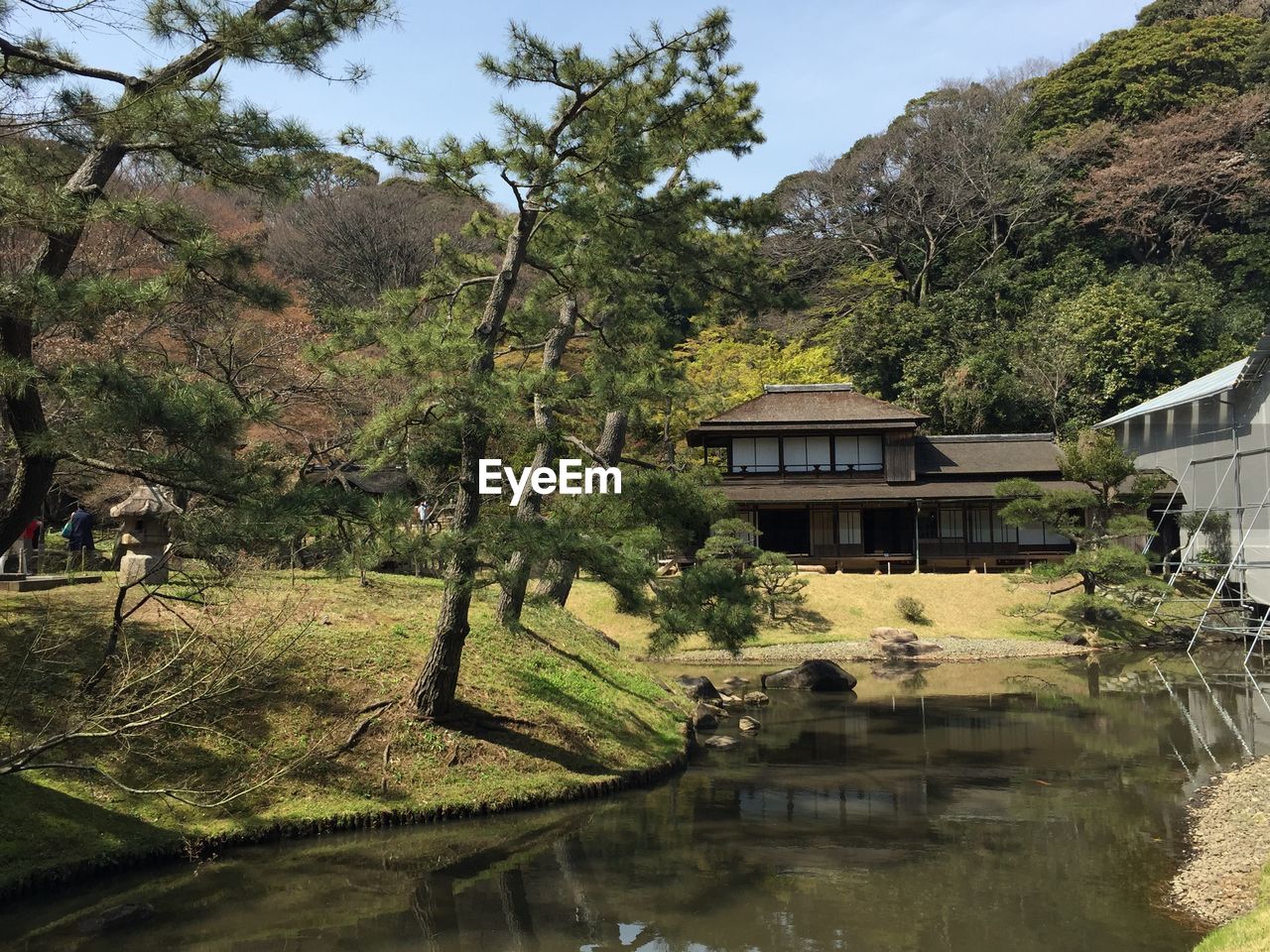 HOUSE BY LAKE AGAINST BUILDING