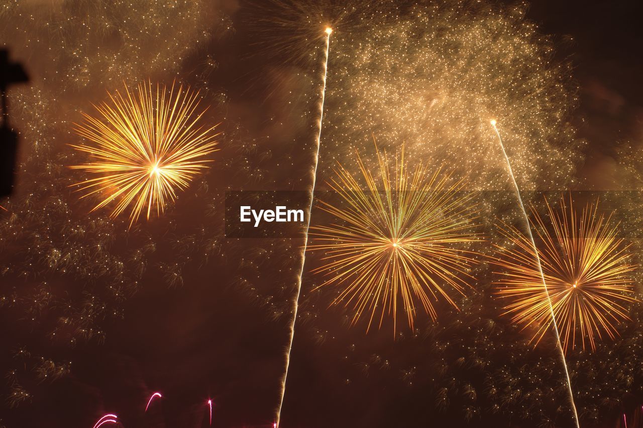 LOW ANGLE VIEW OF FIREWORK DISPLAY