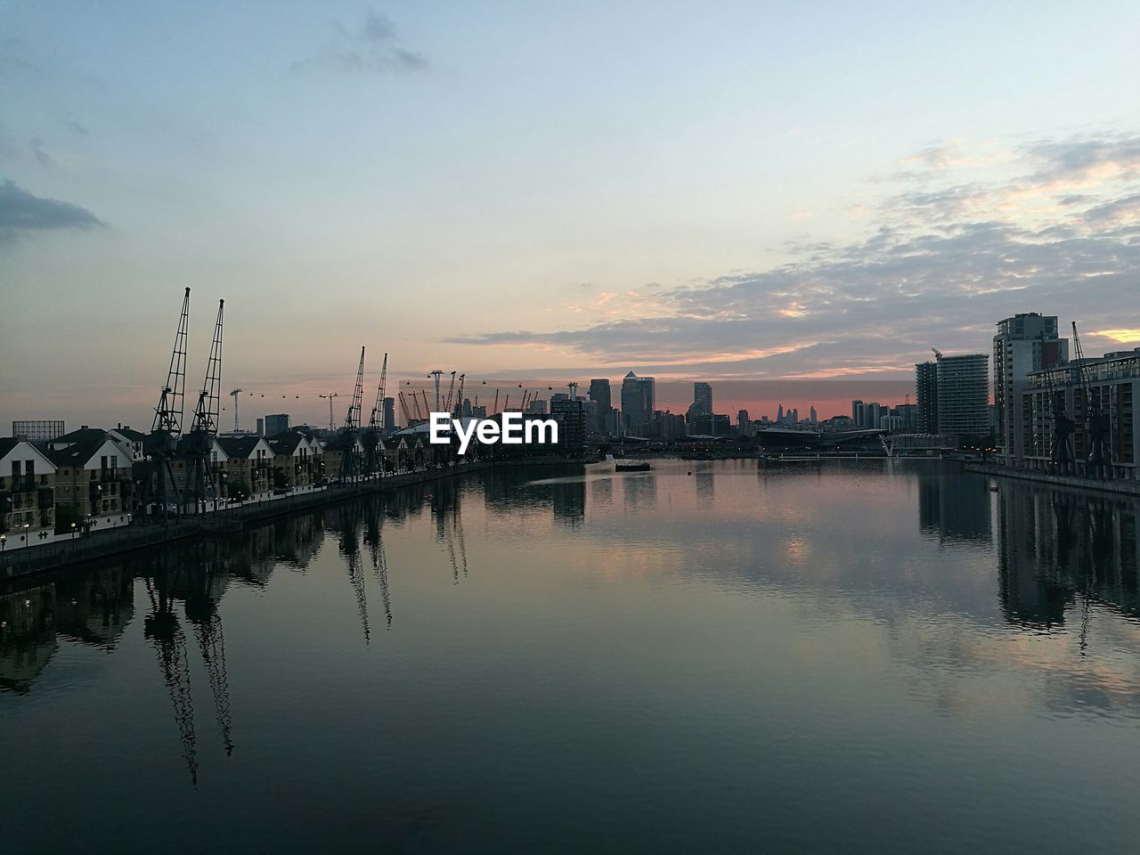 VIEW OF RIVER WITH BUILDINGS IN BACKGROUND