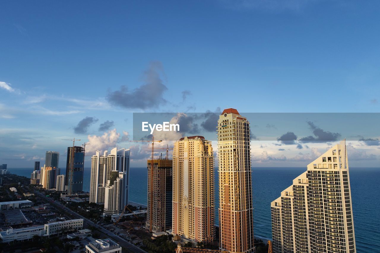 Panoramic view of buildings in city against sky