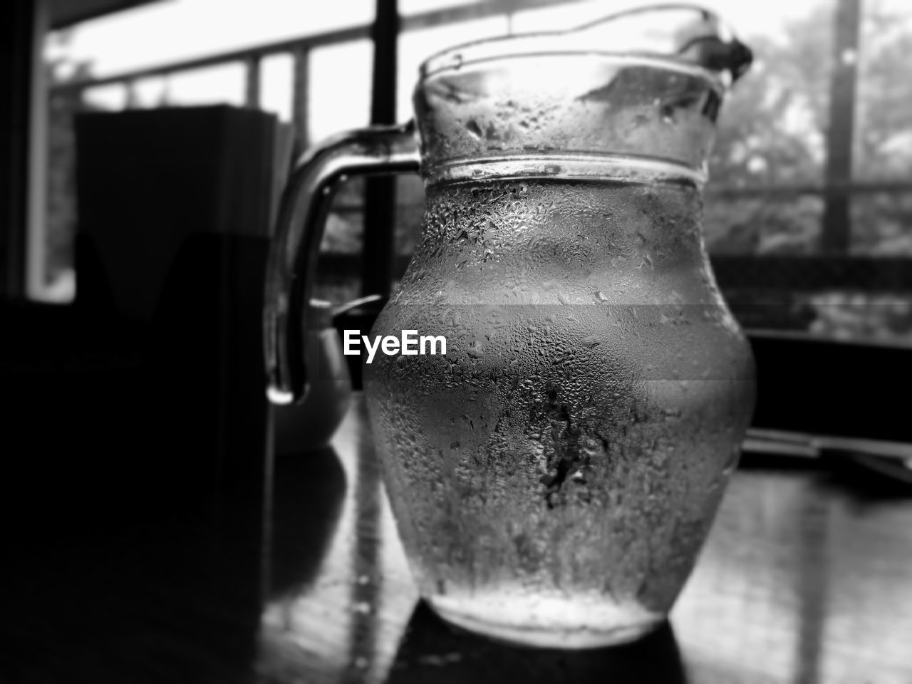 Close-up of glass water in pitcher on table