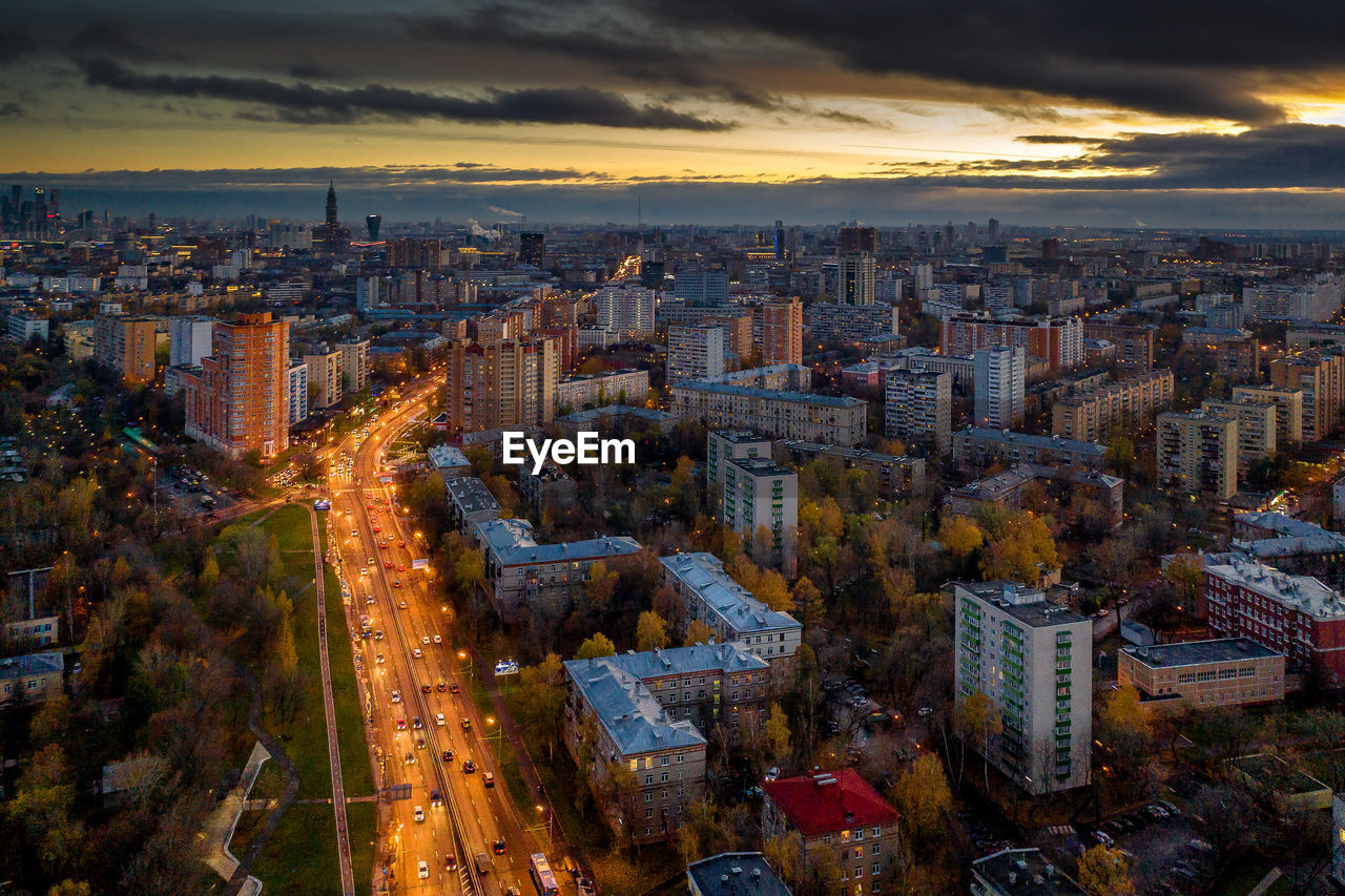 High angle view of illuminated cityscape against sky during sunset