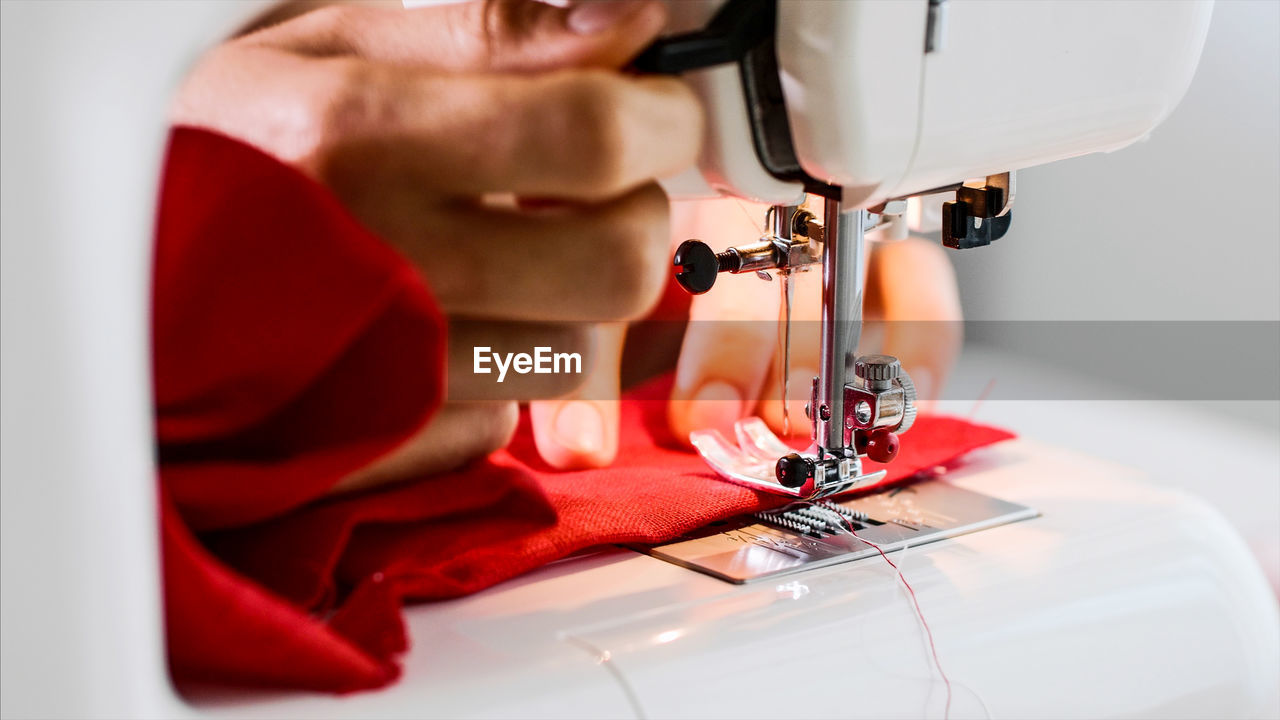 Close-up of person working in machine