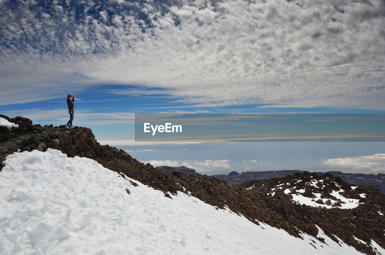 Man standing on snow covered landscape