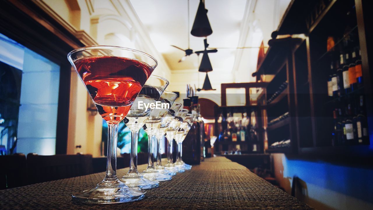 Row of martini glass on bar counter